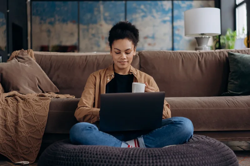Aspiring virtual assistant job hunting on a laptop from home