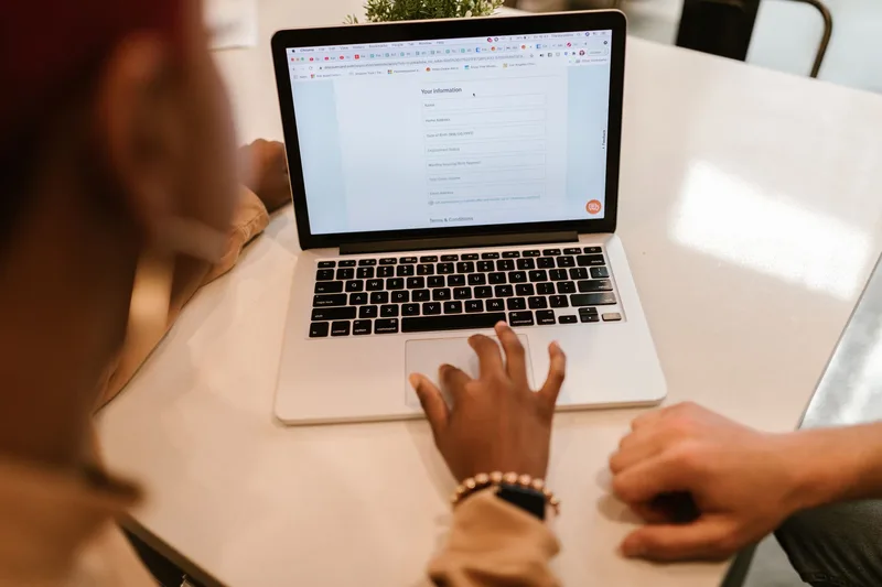 Close-up of a laptop screen showing an online application form being filled out