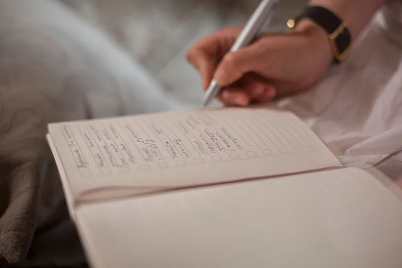 Person writing goals in a notebook to plan a career change