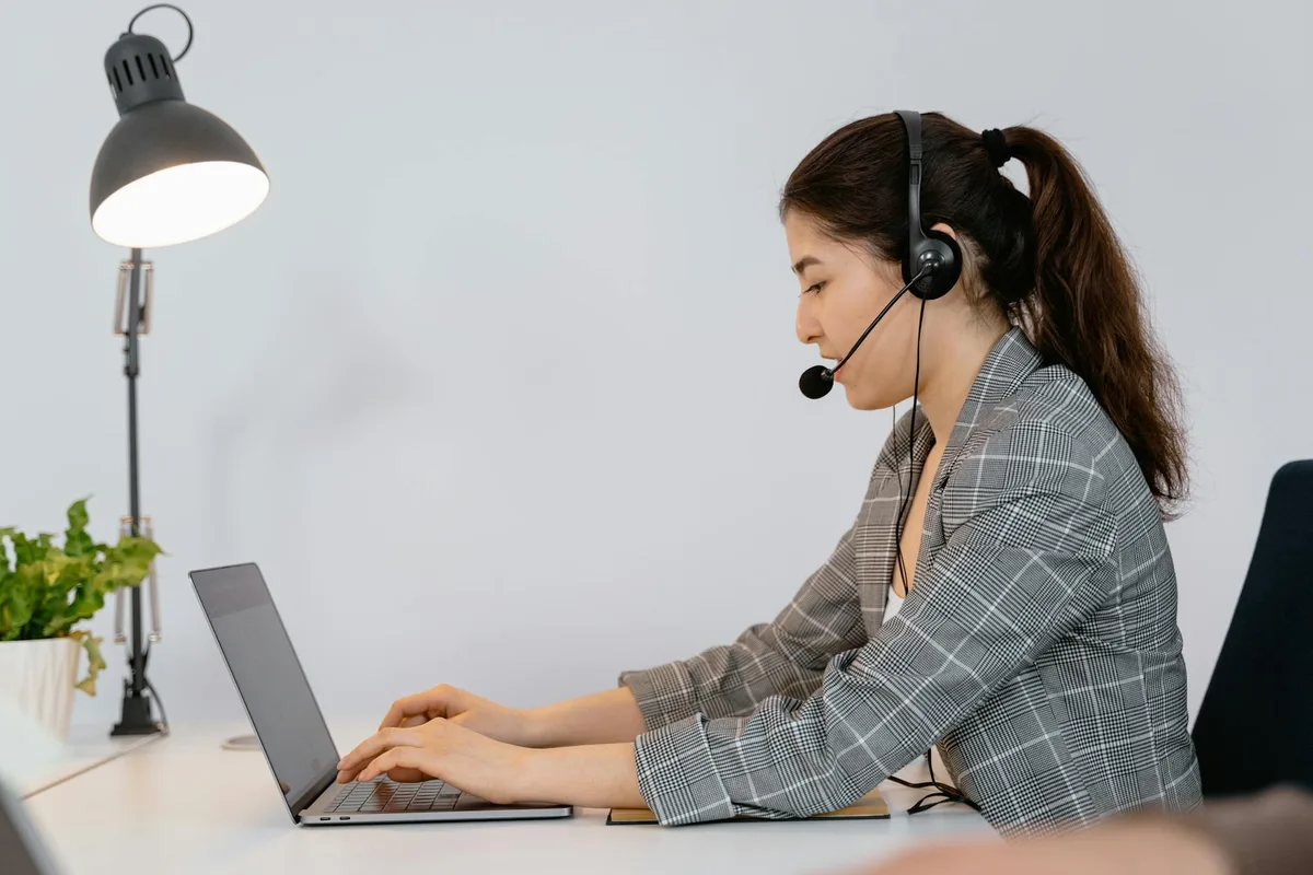 Filipino virtual assistant searching for remote VA jobs on a laptop from a home office