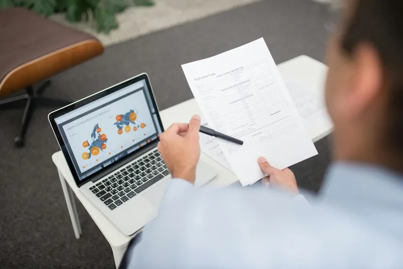 Woman reviewing income benchmarks on her laptop before setting her VA rates