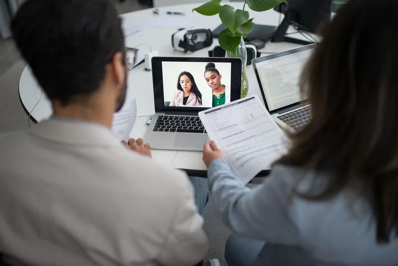 Two professionals conducting a virtual job interview over video call