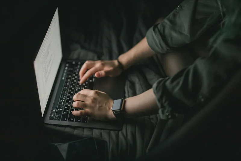 Person applying for virtual assistant jobs online from a home workspace