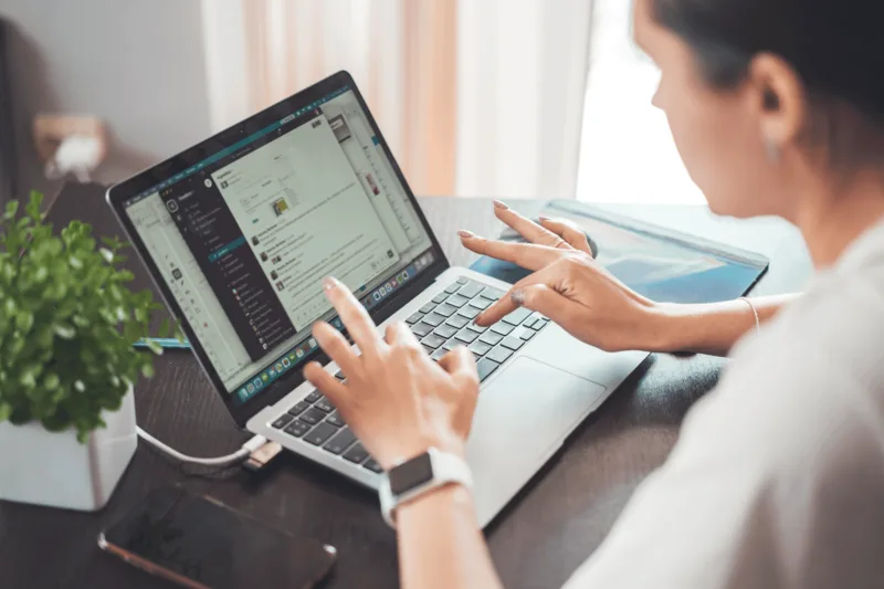Person searching for online VA jobs on a laptop at home