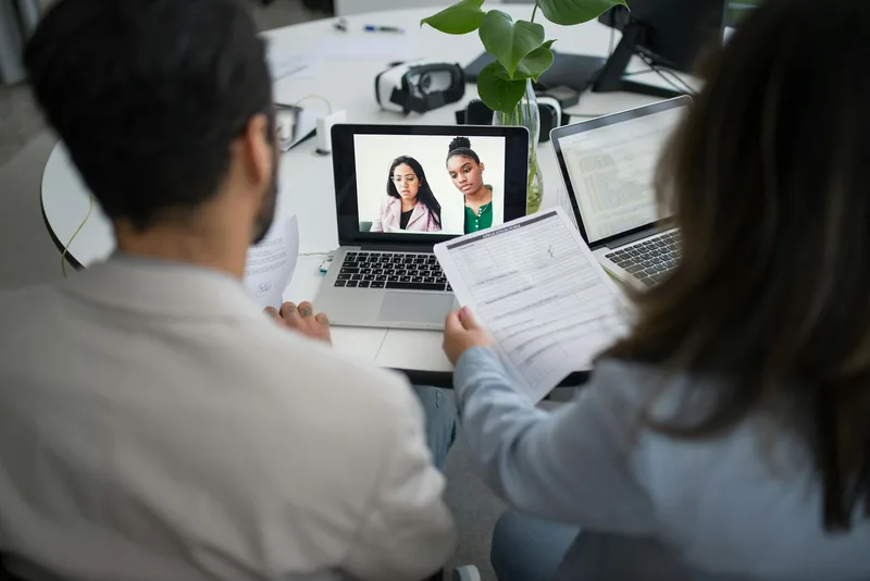 Ecommerce seller reviewing virtual assistant candidate profiles on a laptop