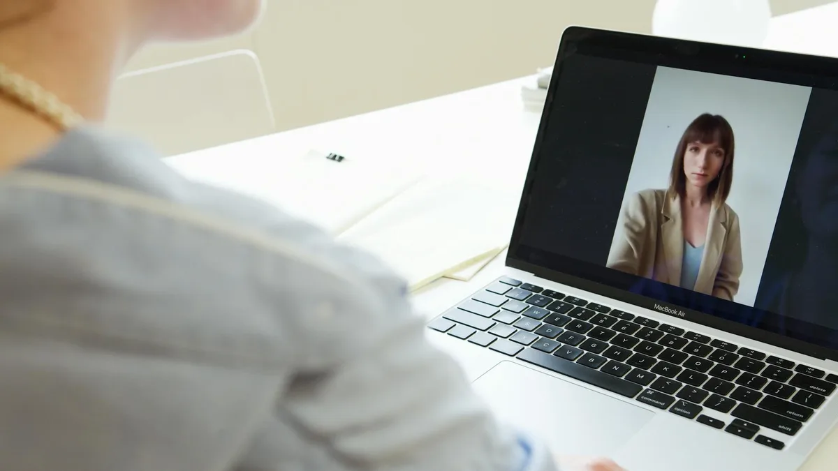 Ecommerce seller on a video call with a virtual assistant applicant, laptop with Shopee dashboard visible