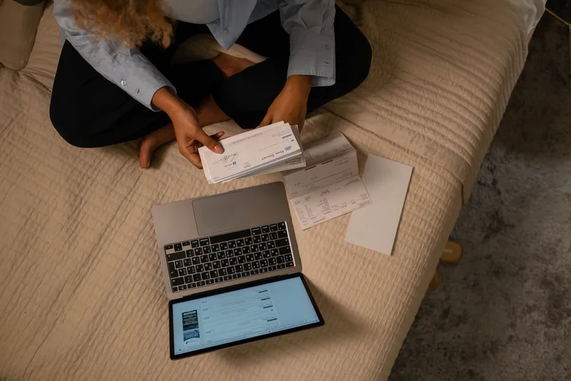 Woman reviewing earnings at a laptop desk representing part-time VA income in the Philippines