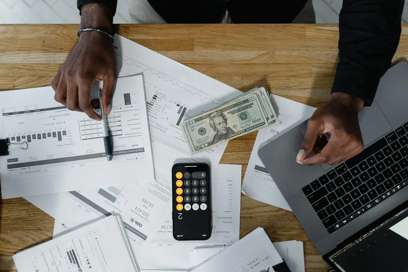 Filipino VA reviewing monthly client reports and tracking earnings on a spreadsheet